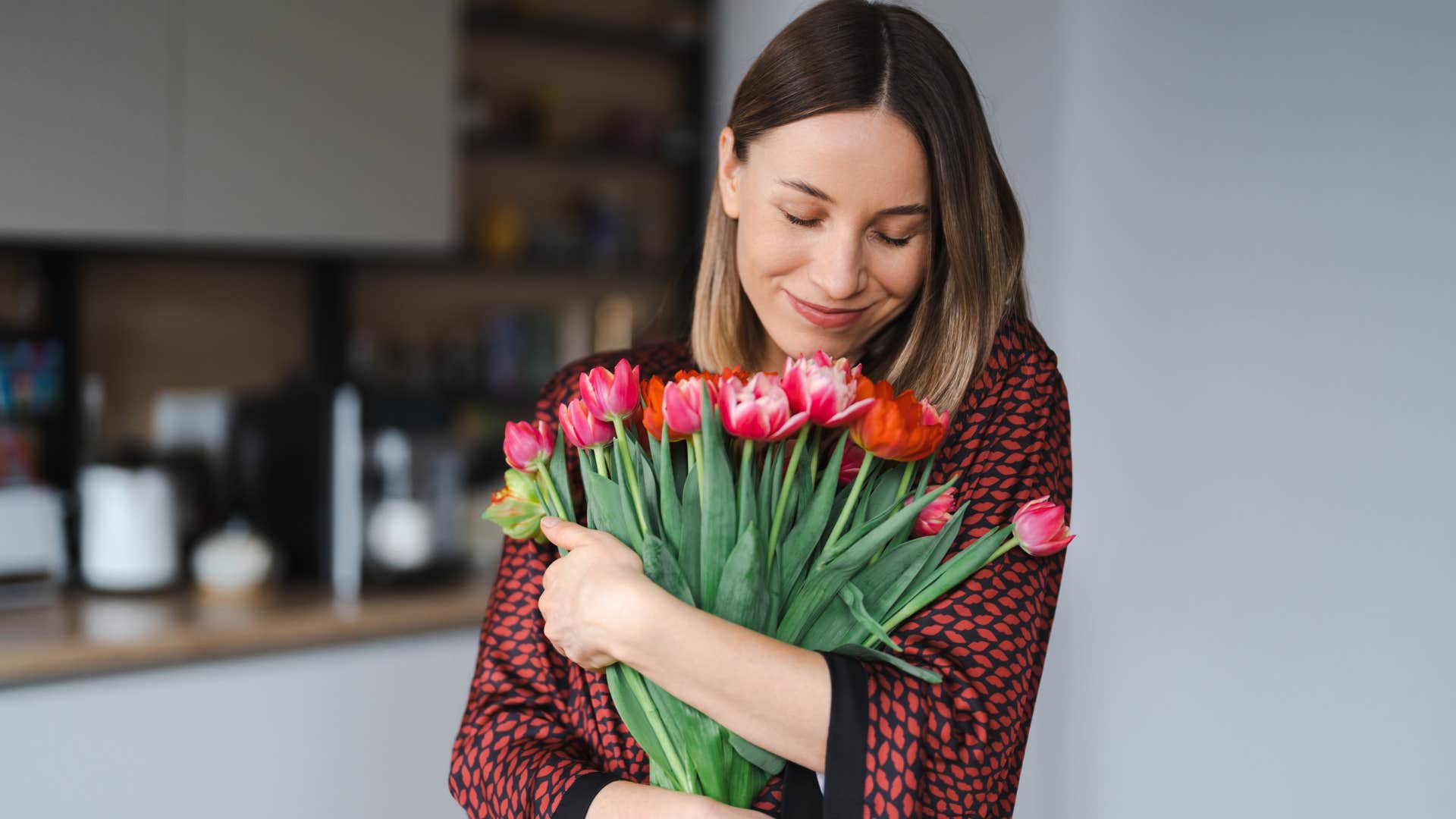 woman celebrating small wins with a bouquet of flowers