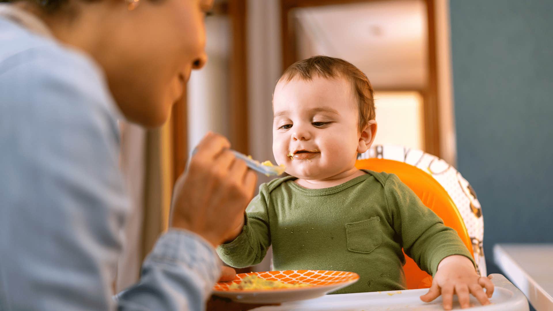 kid being a picky eater as his mom feeds him food