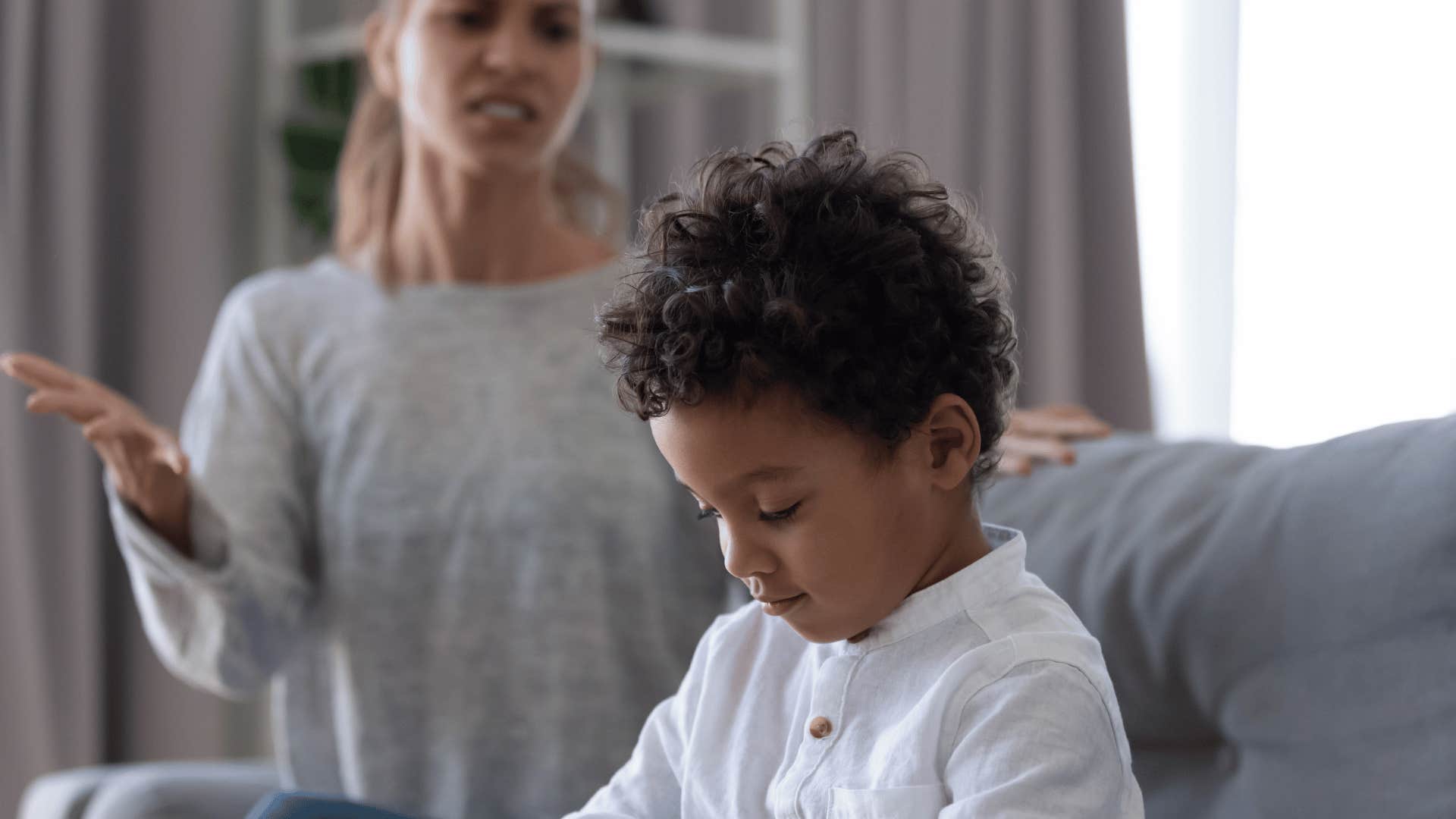 little boy being stubborn and not listening to mom