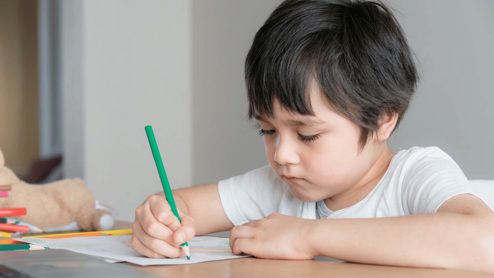 little boy obsessively interested in drawing