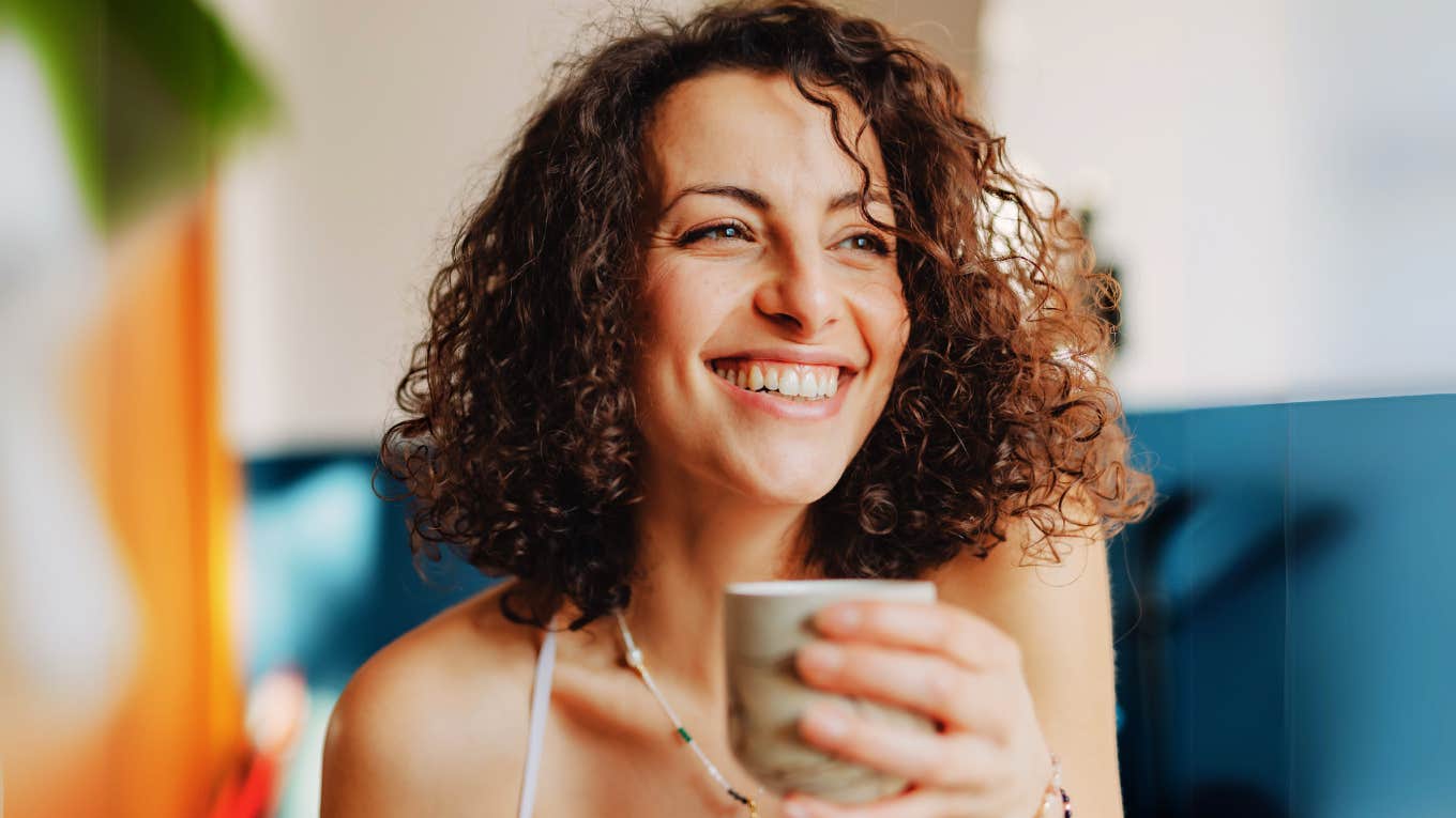 Wildly Underrated Benefits of Practicing Gratitude, According to Science Woman practicing gratitude.