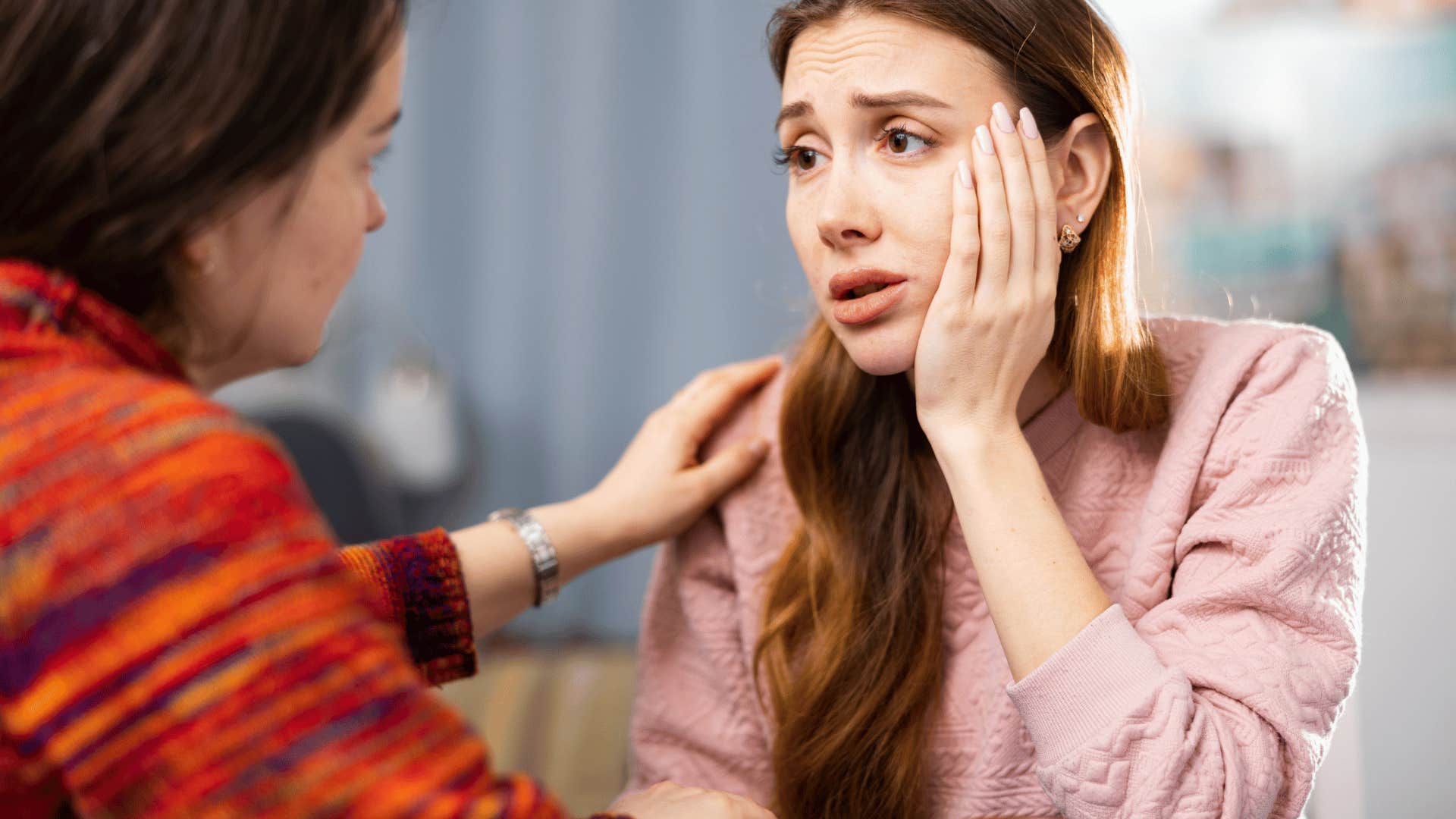 upset woman getting comforted by friend
