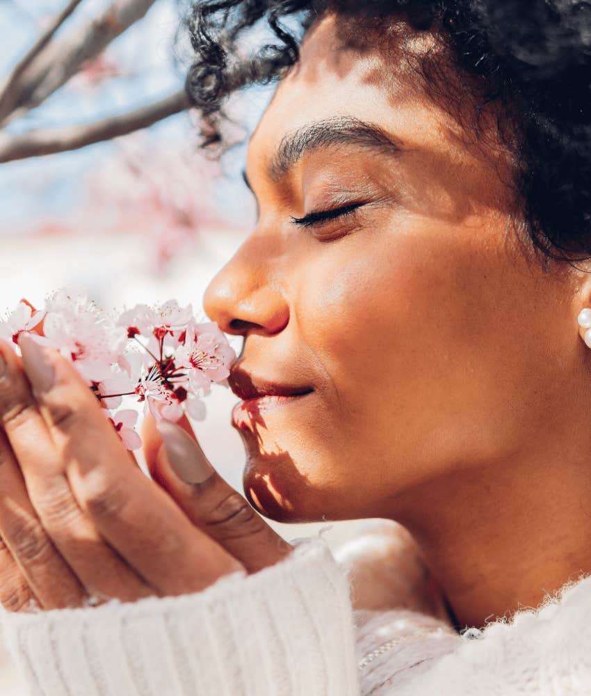 Woman with ADHD smells flowers to zoom out and assess the situation