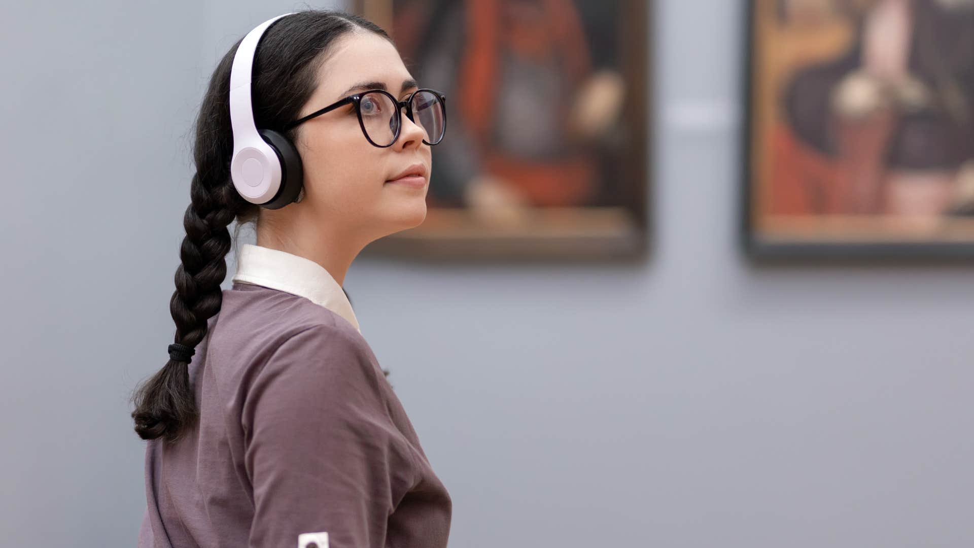 intelligent woman walking around an art museum