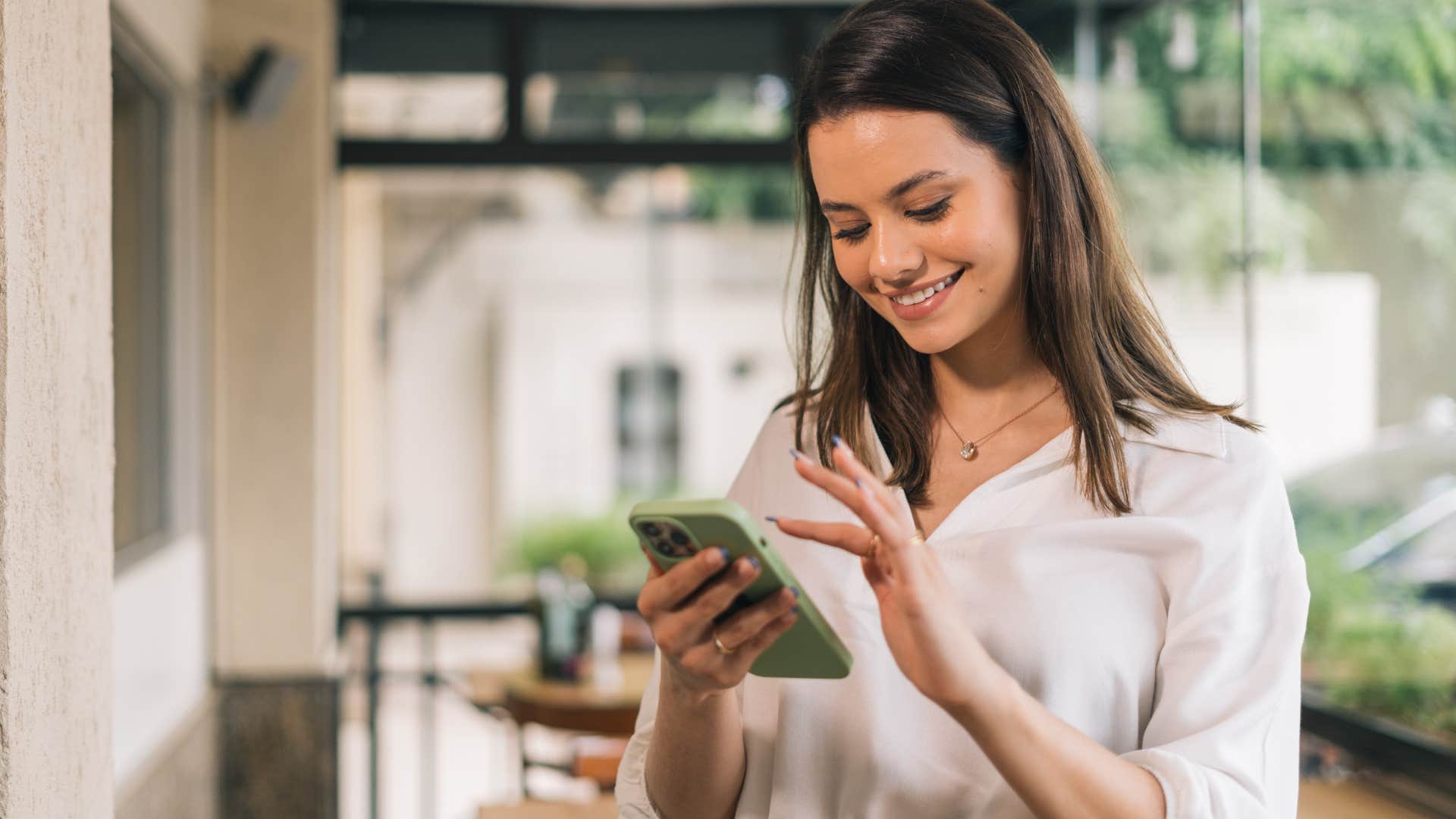 woman reading about culture on her phone