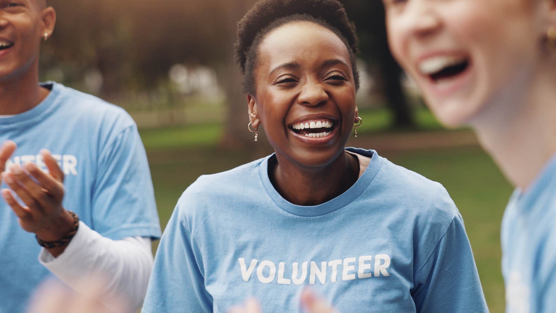 intelligent woman smiling and volunteering with friends