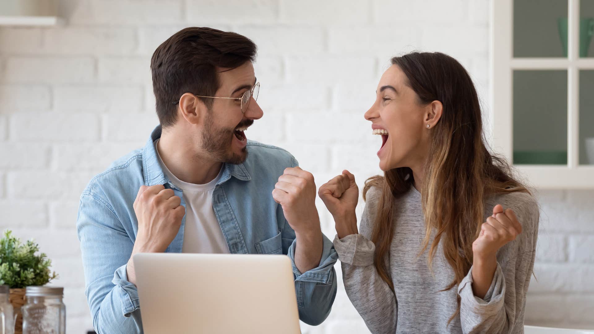 A husband supports his wife’s business goals as they celebrate together.