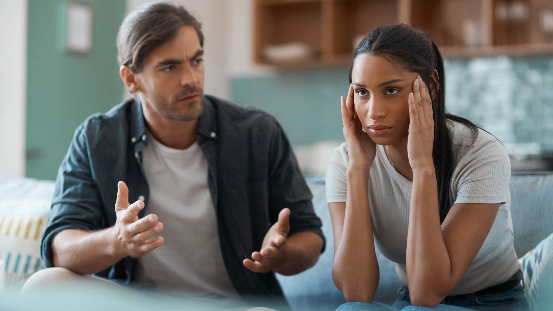 Man saying "Why are you always blaming me?" to his annoyed wife.