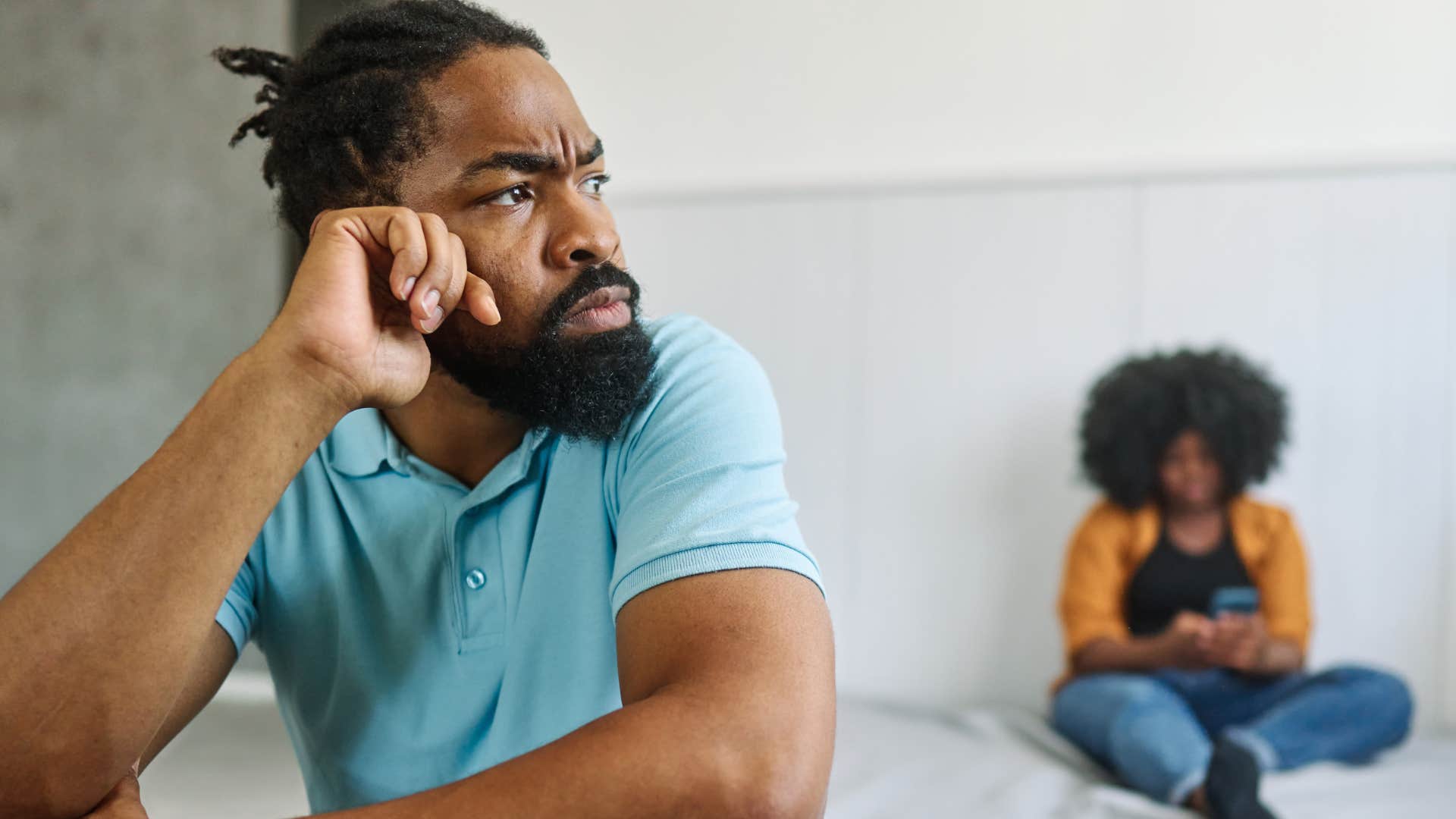 Upset man saying "I'm fine" to his partner.