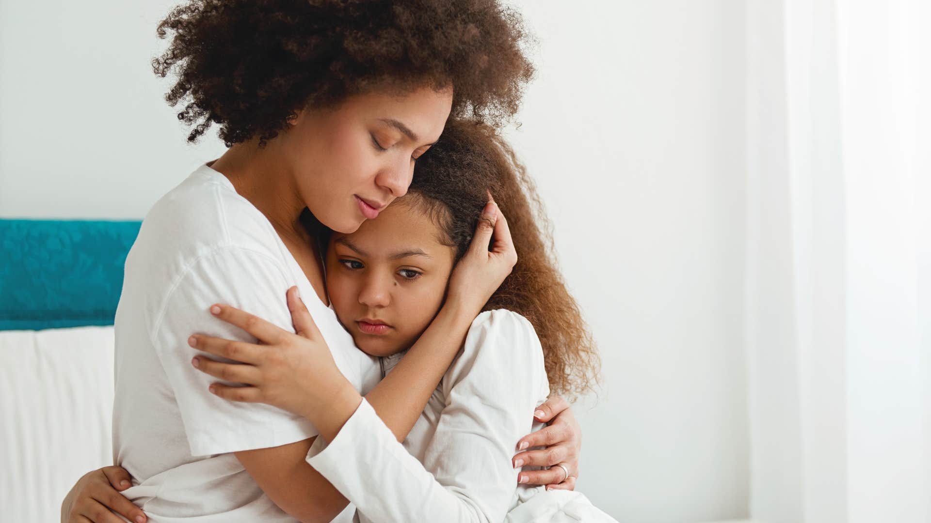 mom comforting little girl after having a nightmare