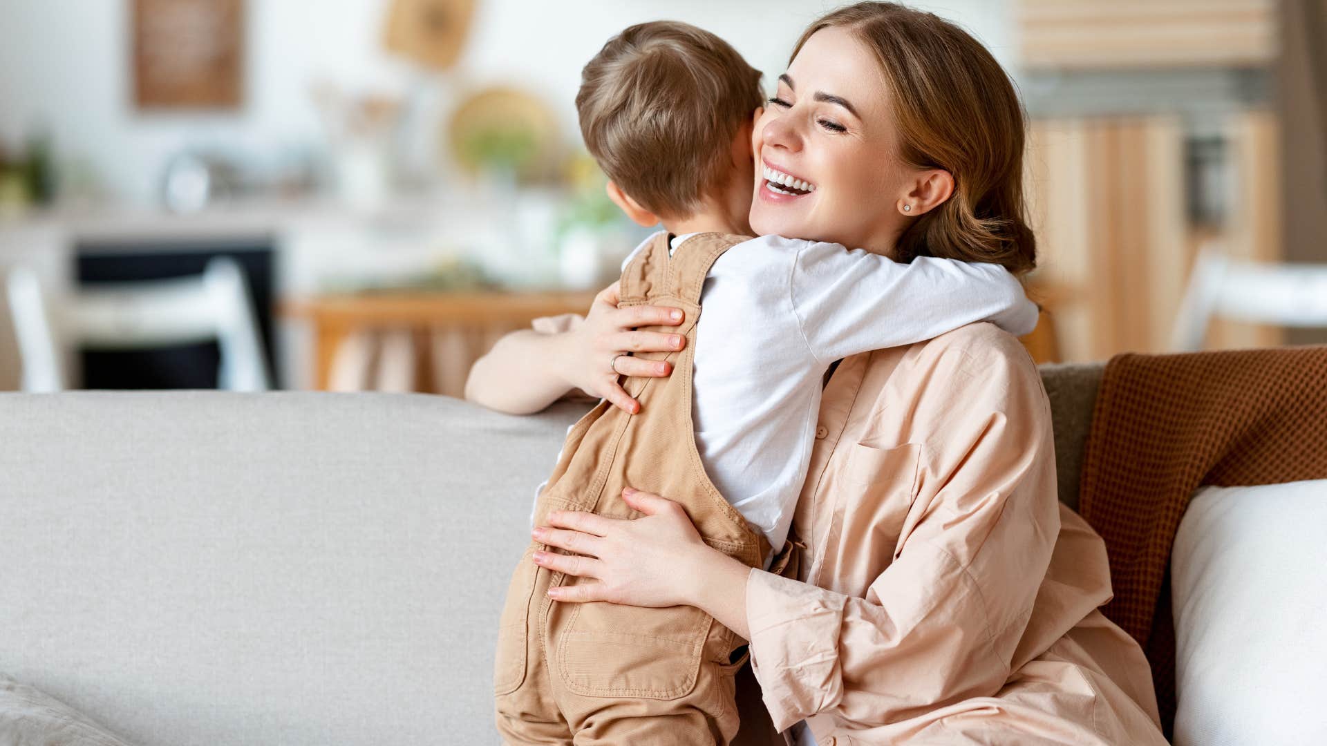boy hugging his mom after getting a surprise