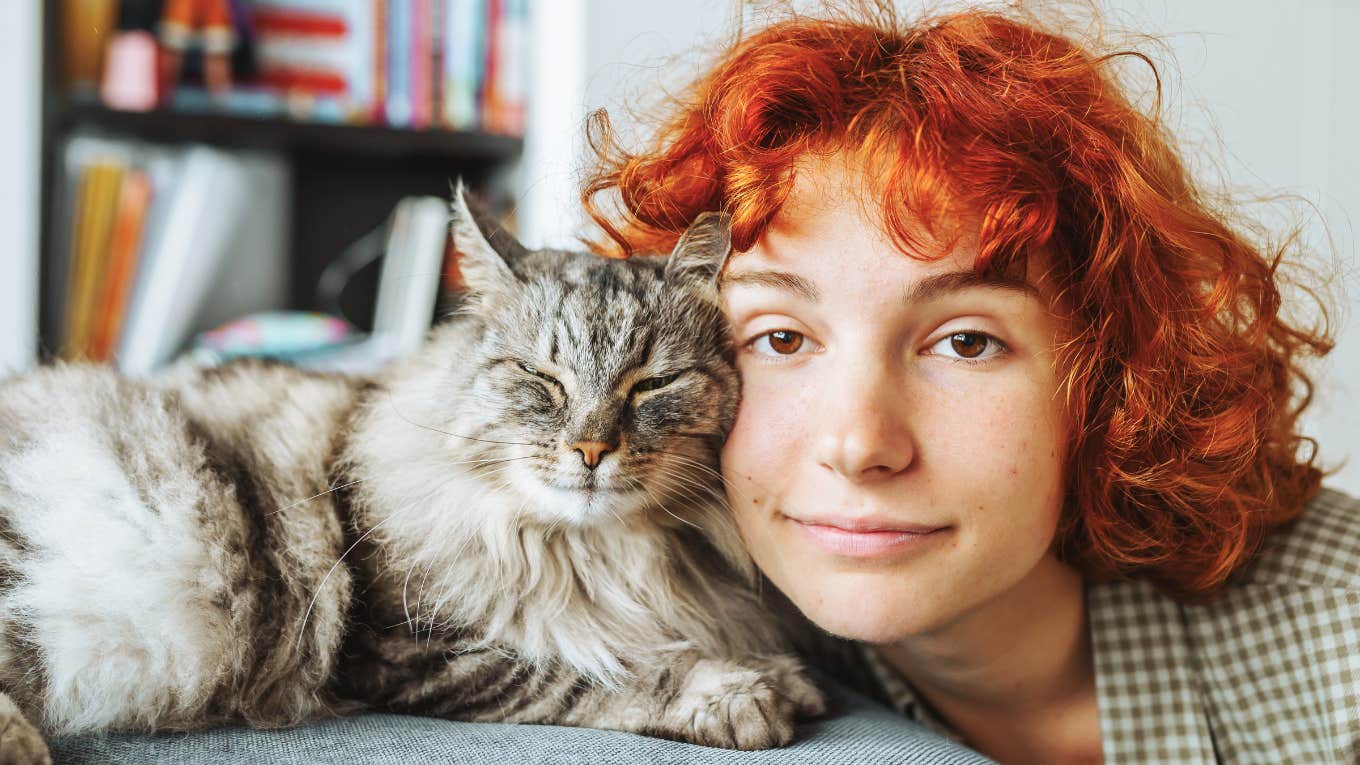 Adorable Things Cats Only Do If They See You As Their Mom Or Dad adorable cat snuggling with happy young woman