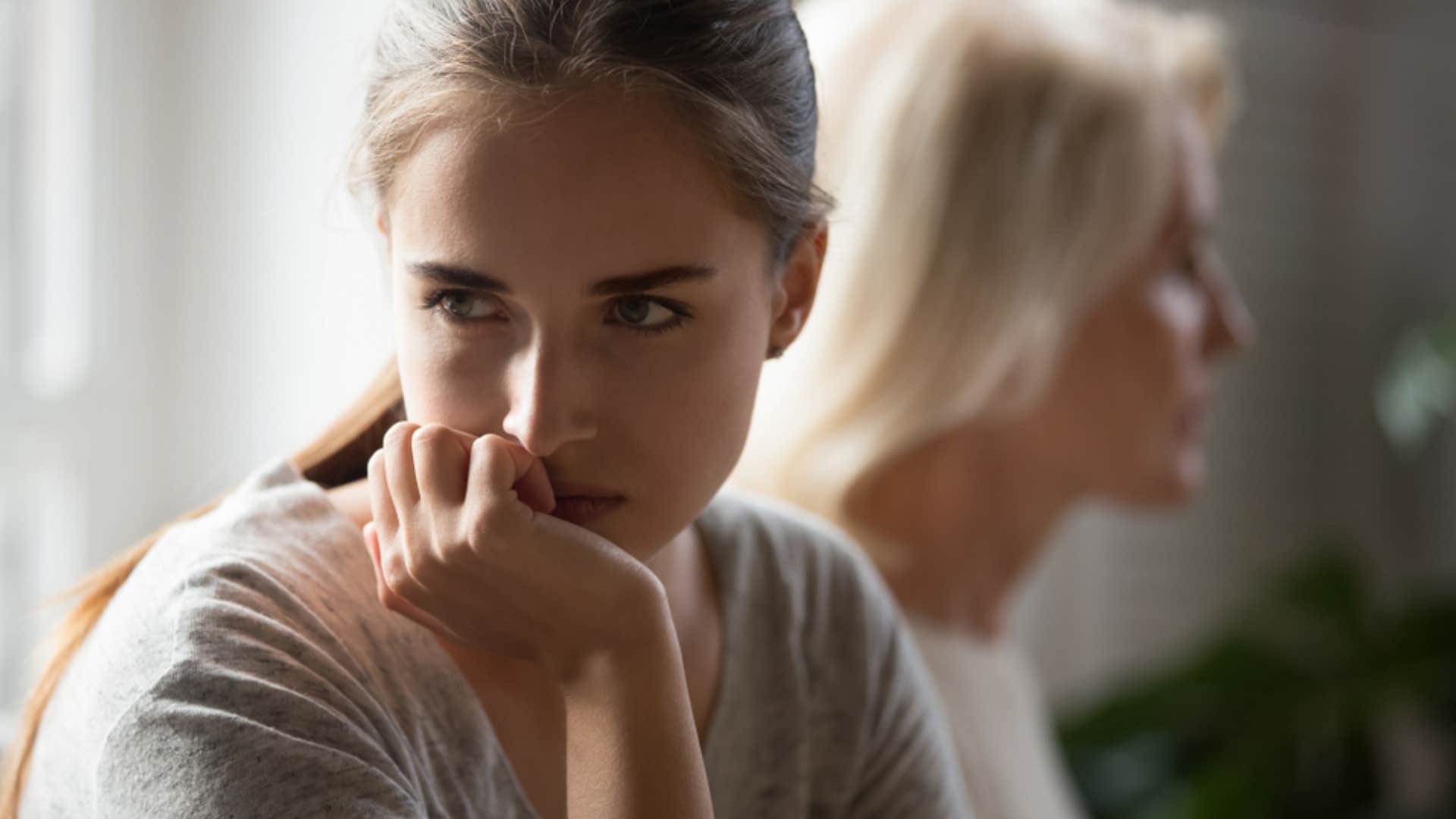 stubborn woman avoiding talking to mom about their issues 