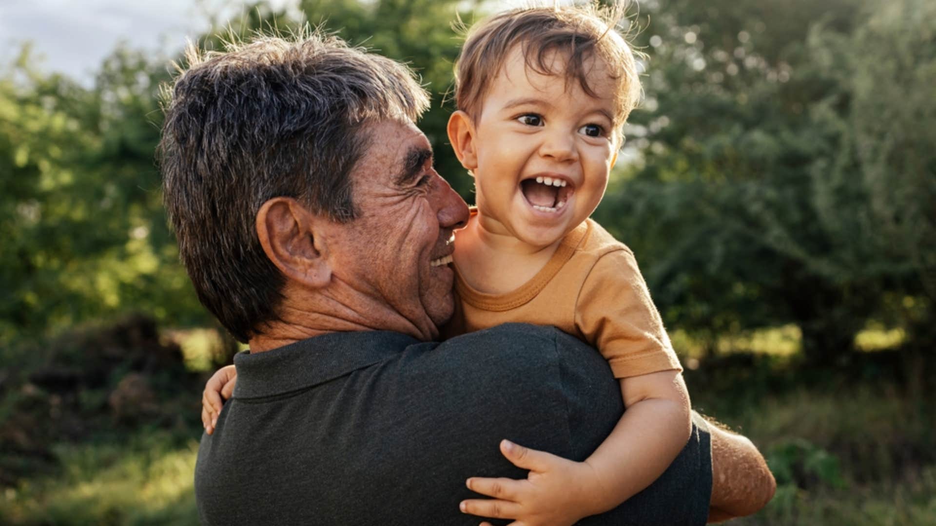 grandpa holding grandchild forming a strong bond