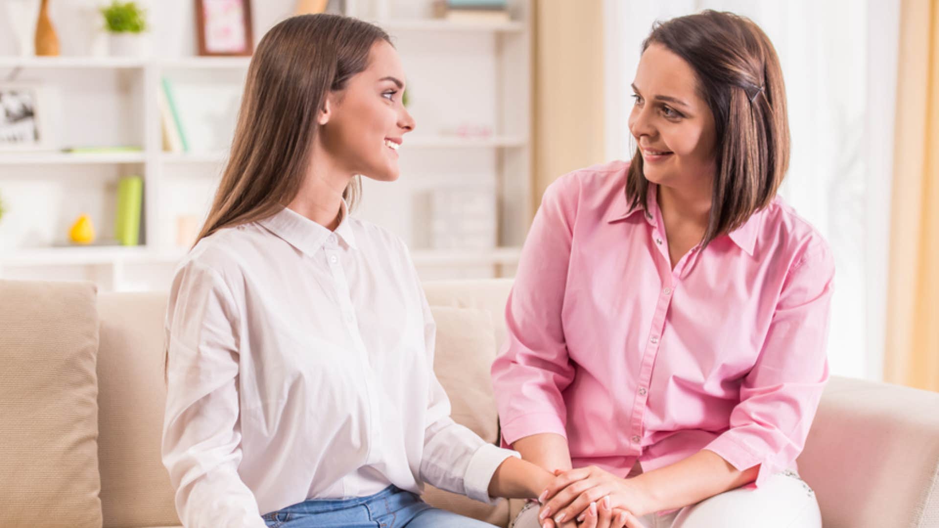 smiling woman talking to older mom out of guilt 