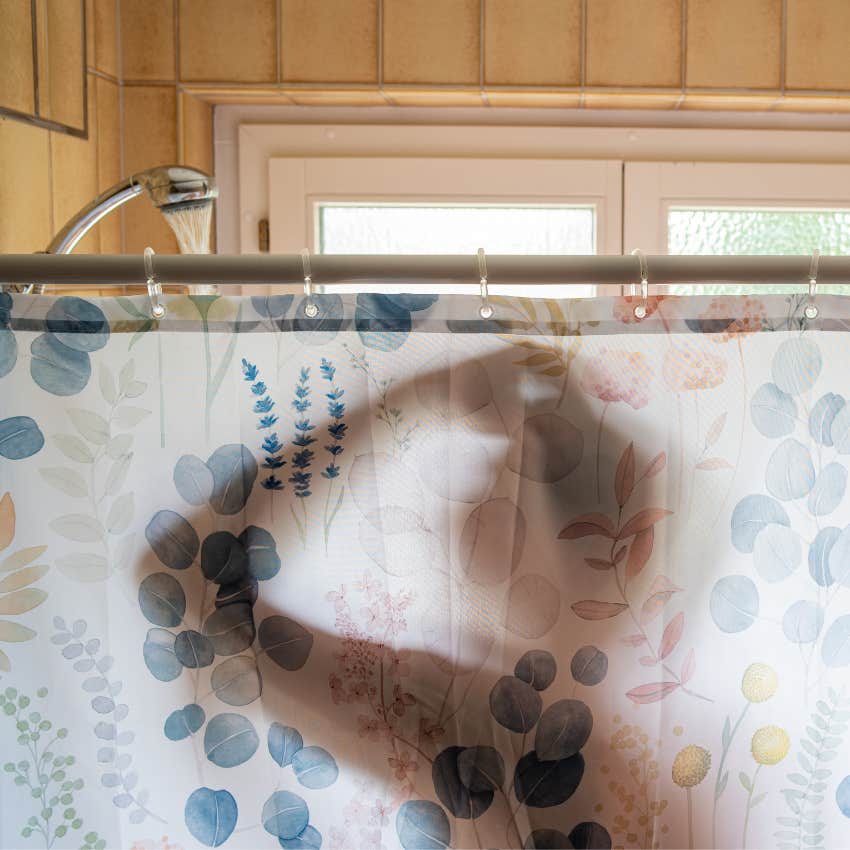 man taking a shower to become a morning person