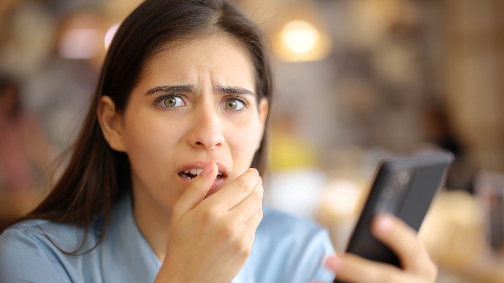 a woman is horrified that she has been included into a group chat
