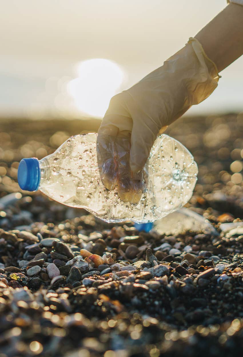 picking up recyclables on a beach