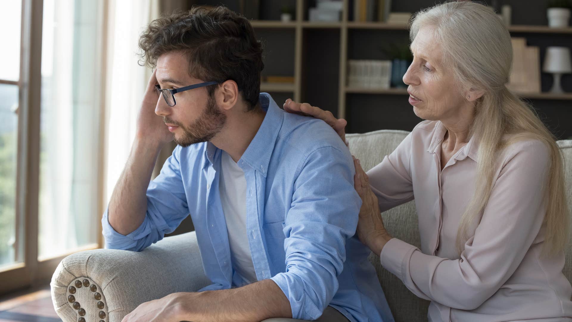 older woman telling her adult son hes acting like an adult