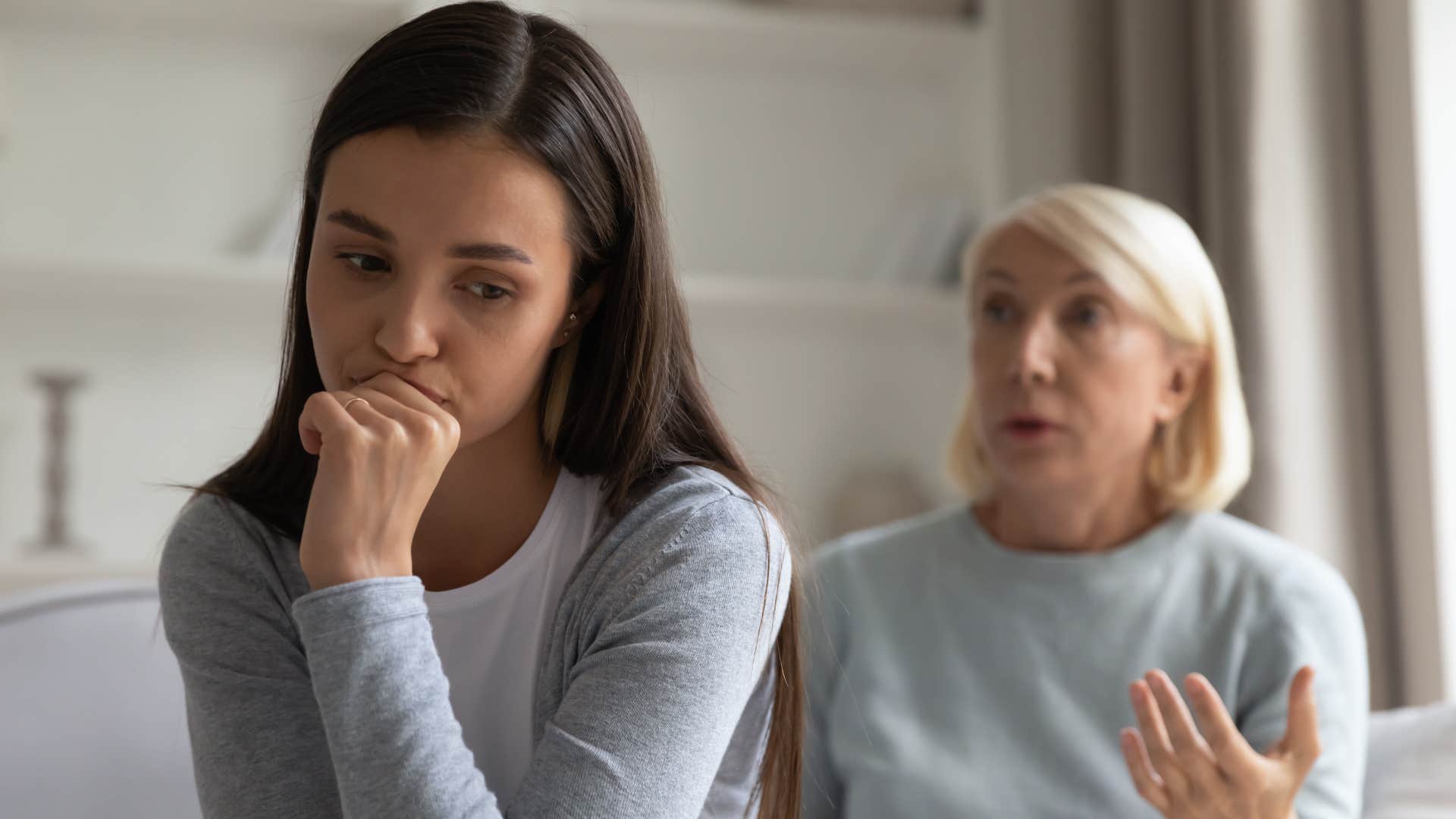 woman condescendingly telling adult daughter shes proud of her