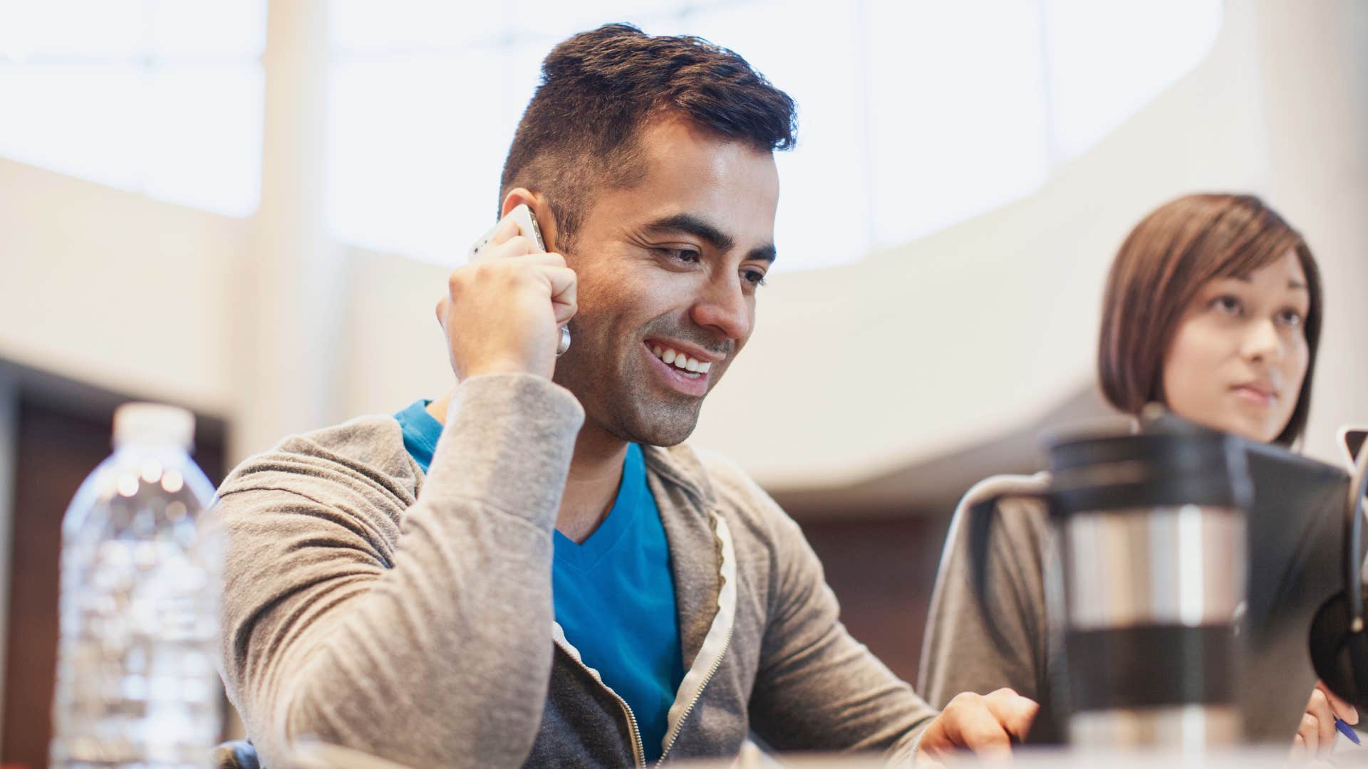 man who seems rude being on the phone during a meeting