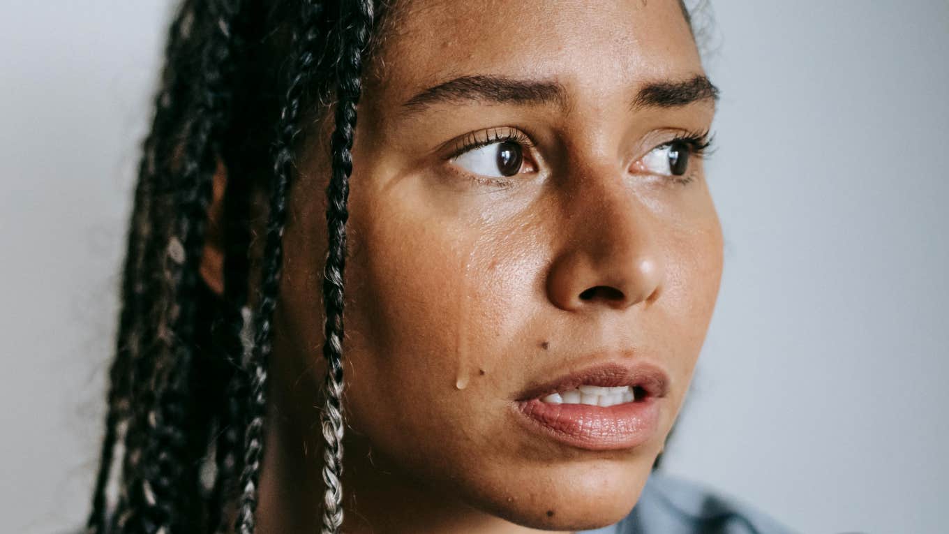 Rare Behaviors That Reveal Someone’s Still Carrying Trauma, According To Mental Health Experts Woman is still carrying trauma.