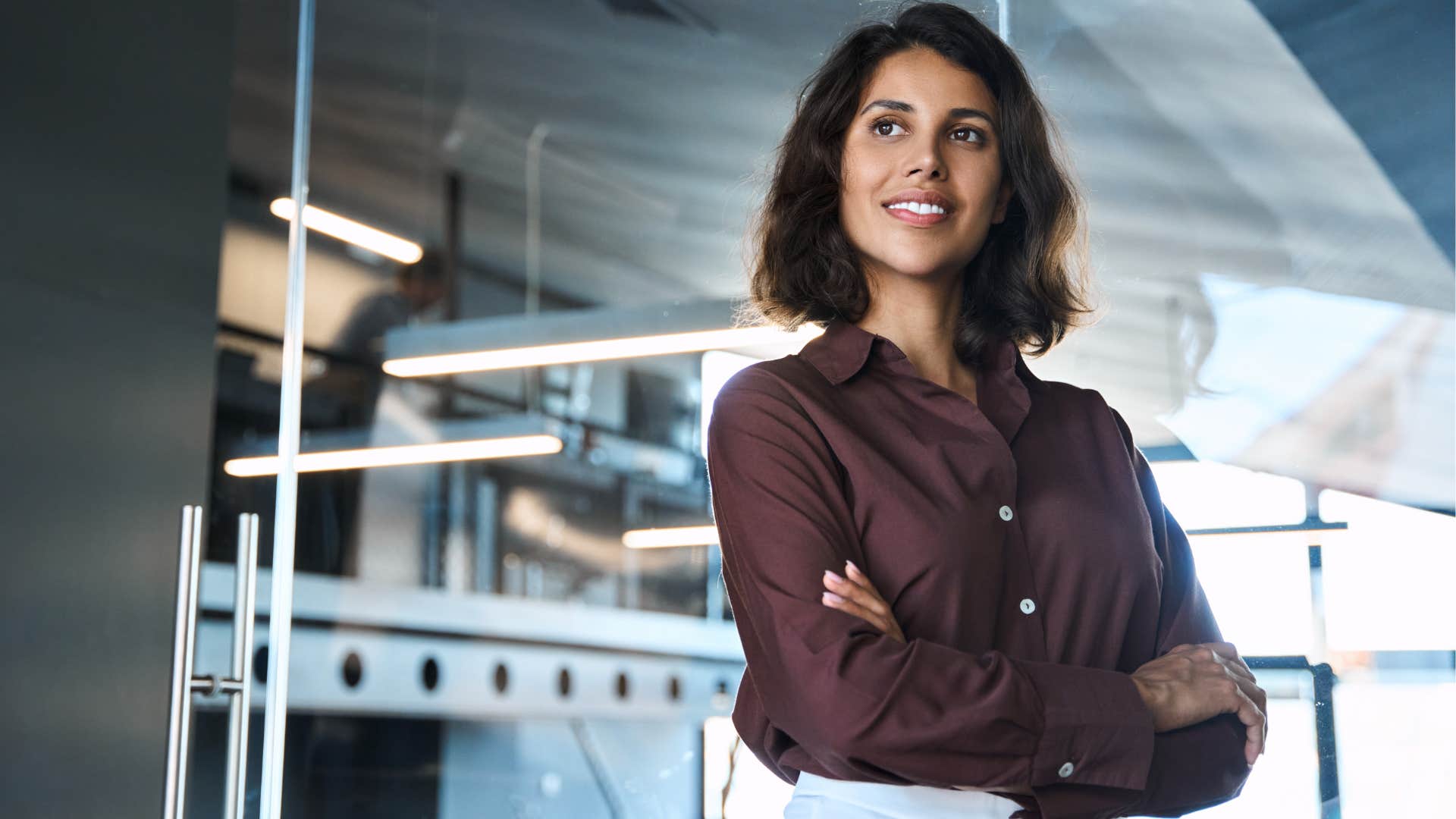 Woman who accepts challenge smiling in her office.
