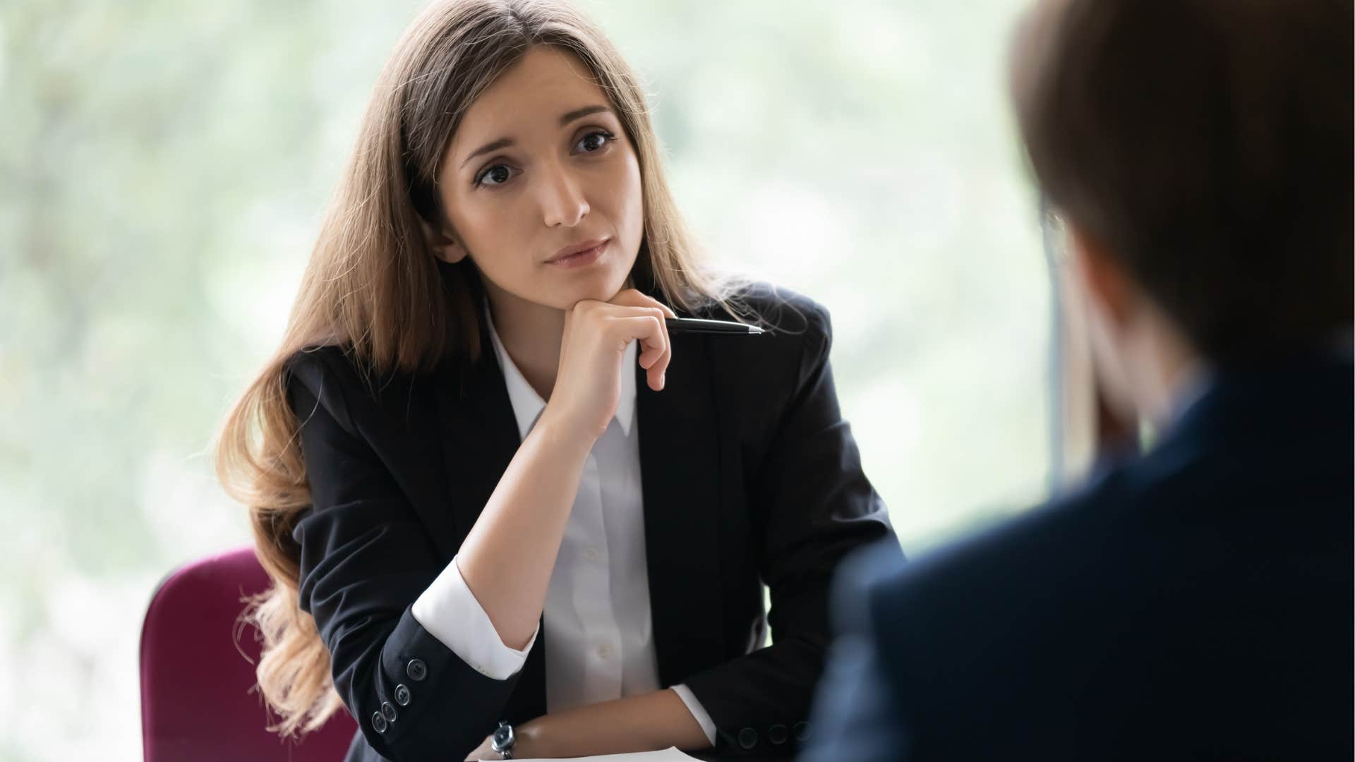 Woman who's calm under pressure looking at a male co-worker.