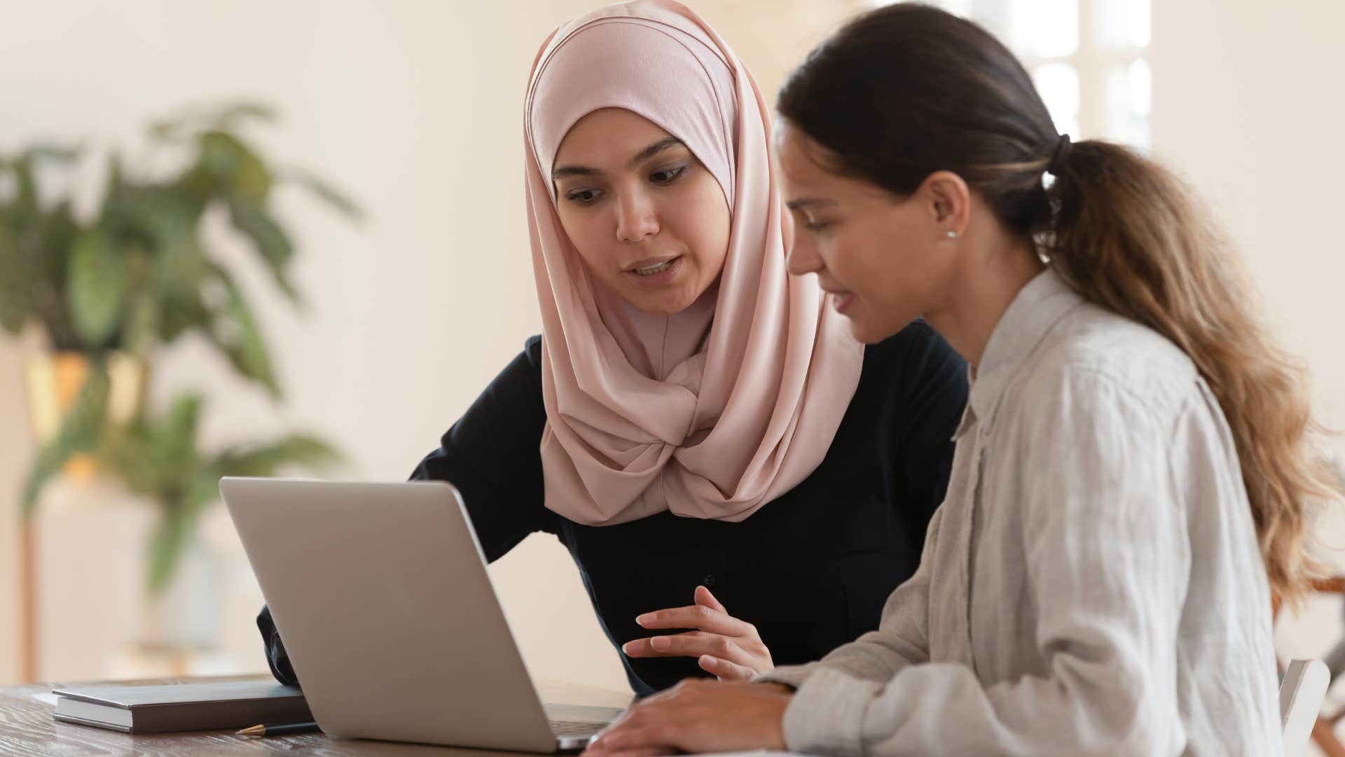 Woman who is kind to everyone talking to a co-worker.