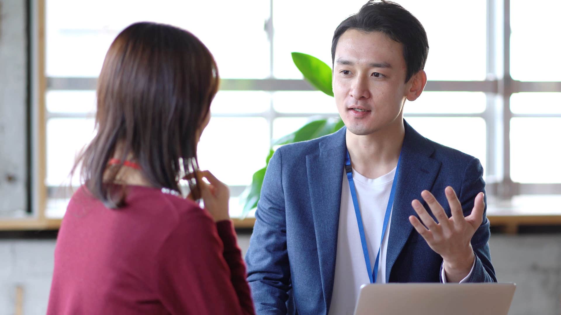 man refusing to nod head while talking to co-worker