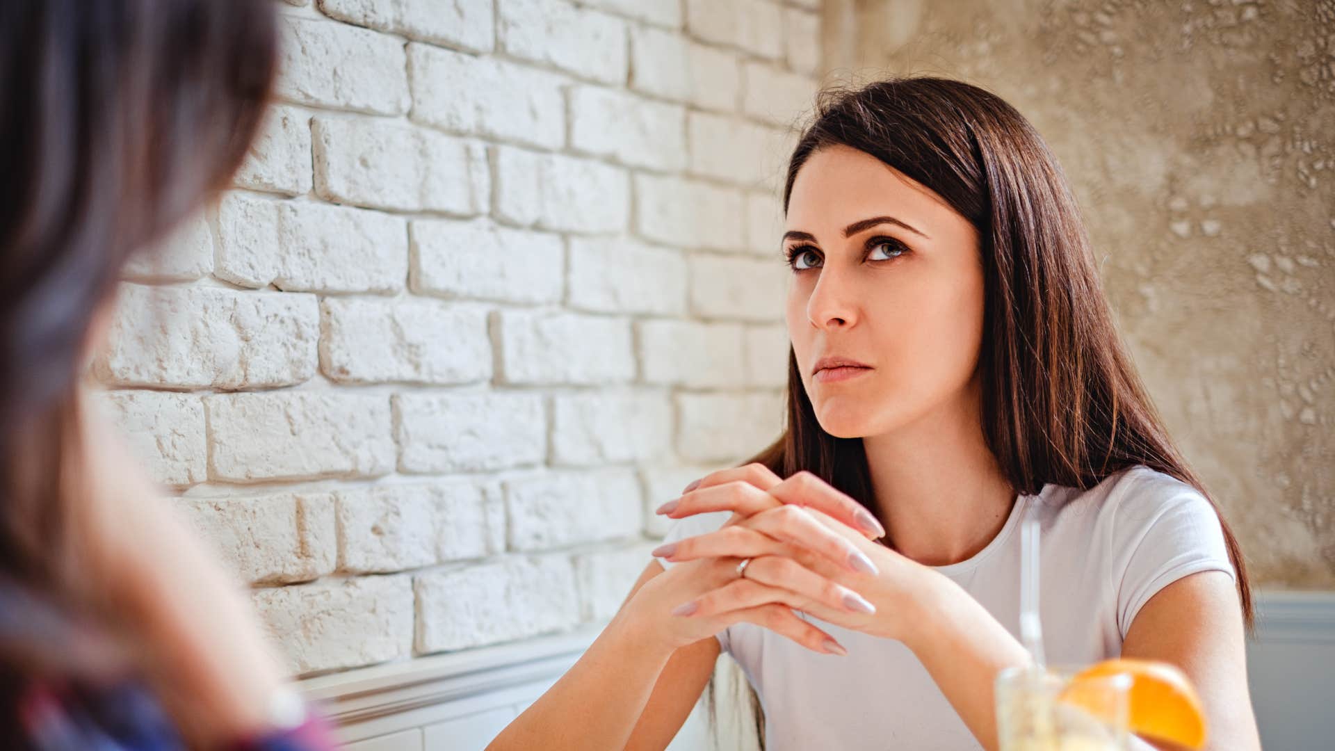 woman glancing at exit during boring conversation