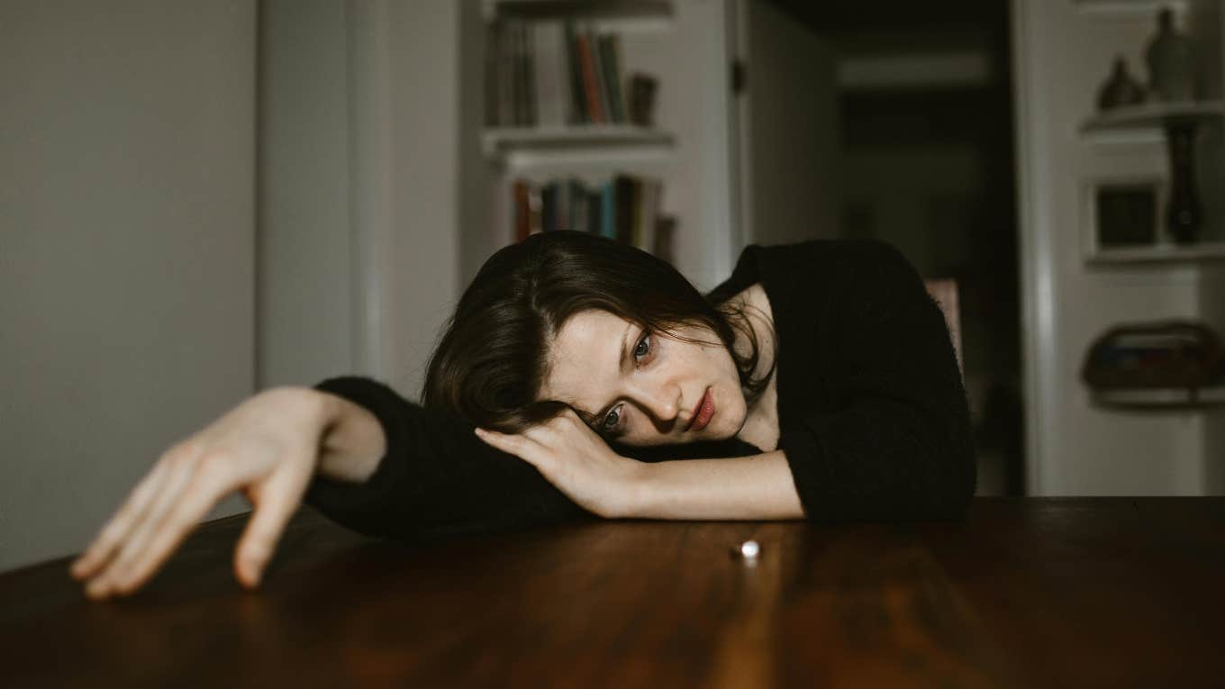 Bride Cancels Wedding Over Fiancé's Secret Bank Account Bride sad and looking at her ring after canceling her wedding over her fiancé's secret bank account