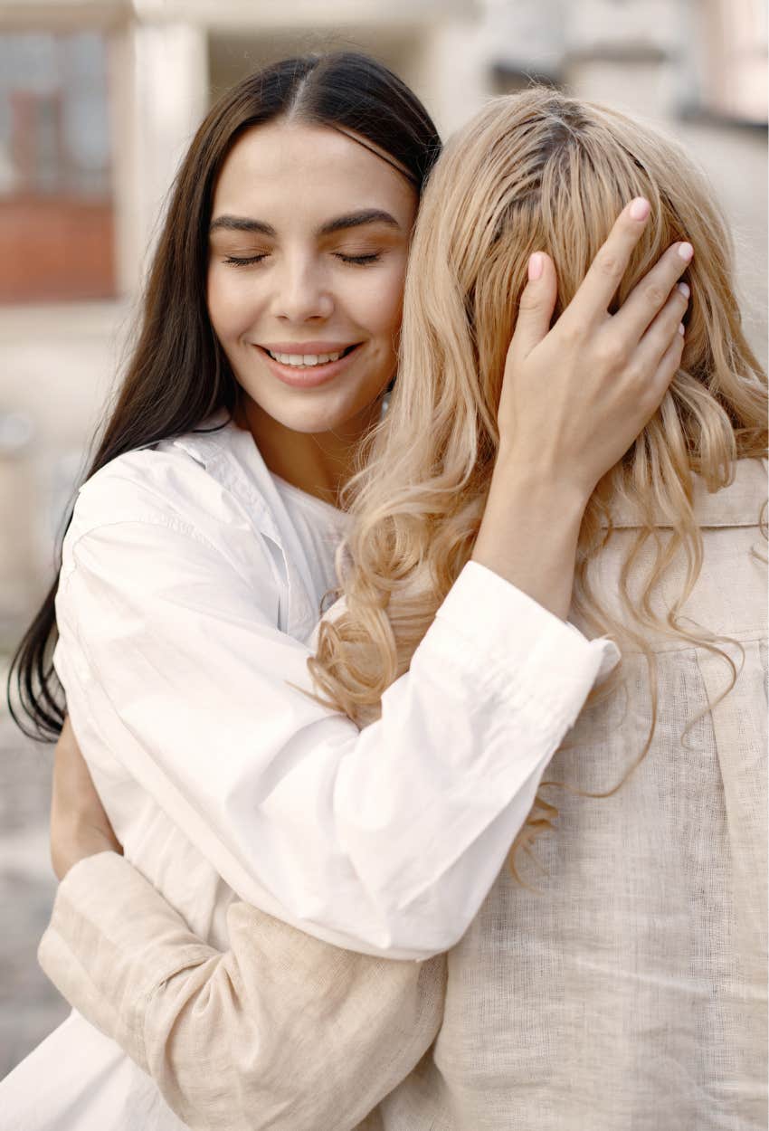 bride and pregnant bridesmaid hugging because neither woman is wrong