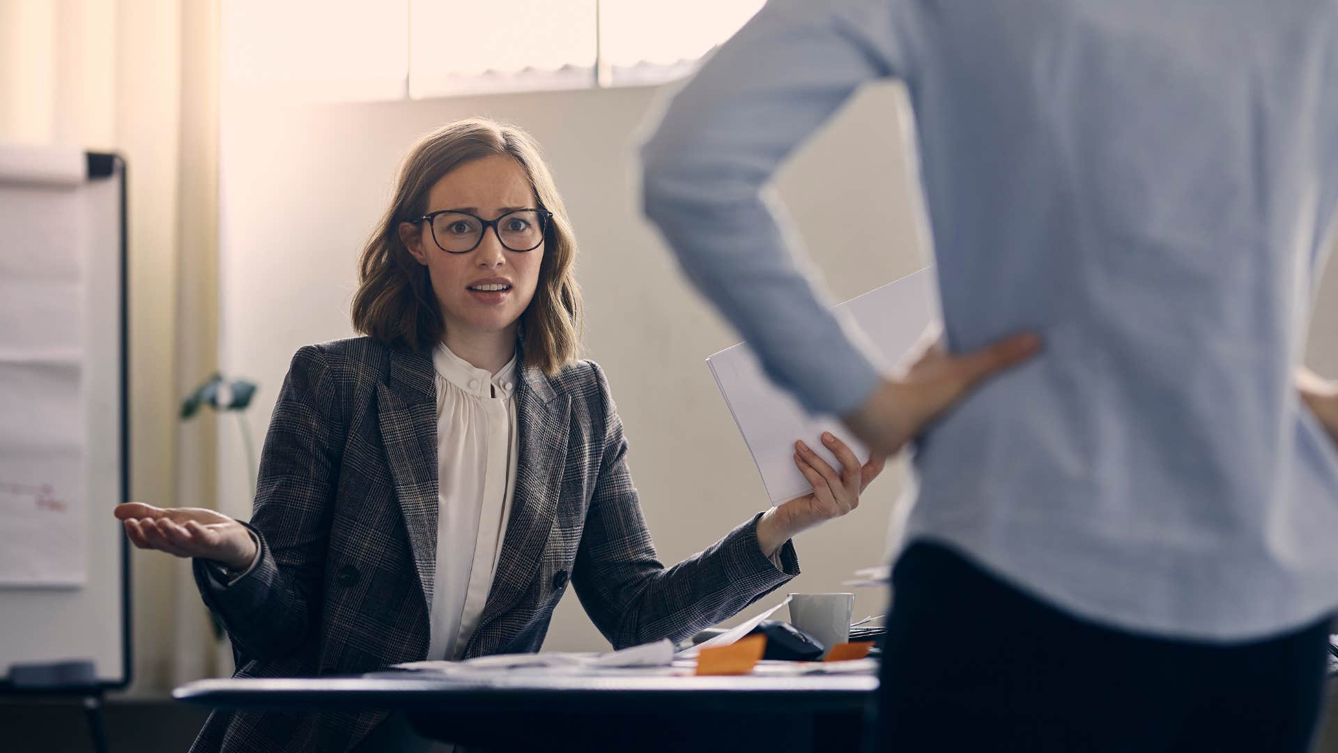 a woman sets a clear boundary with a man at work