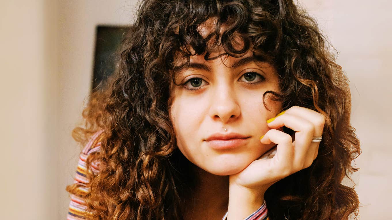 5 Calming Rituals For When Everything Feels Like Too Much, According To Intuitive Coach Woman who's using calming rituals.
