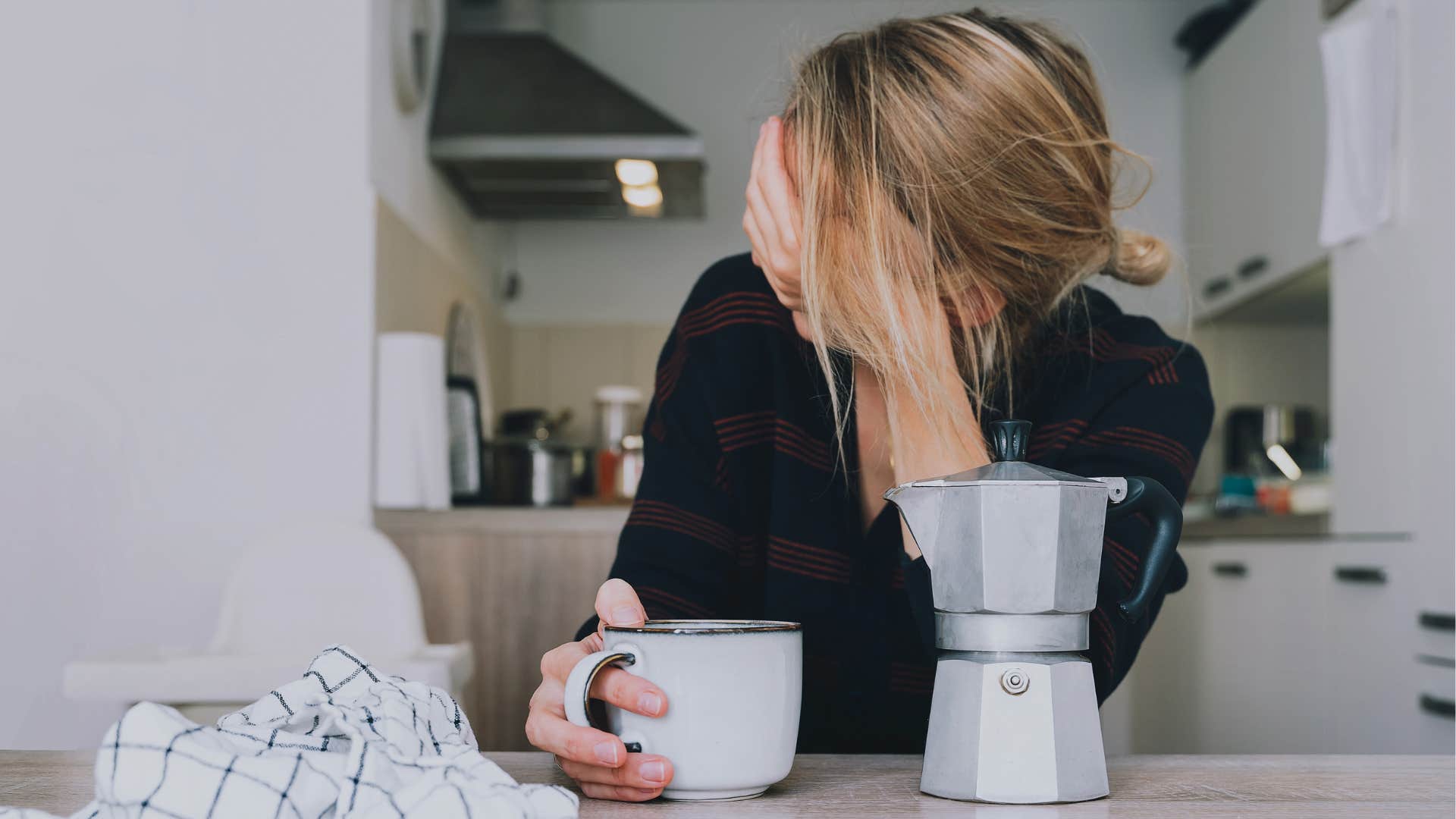 woman struggling with basic tasks holding her head