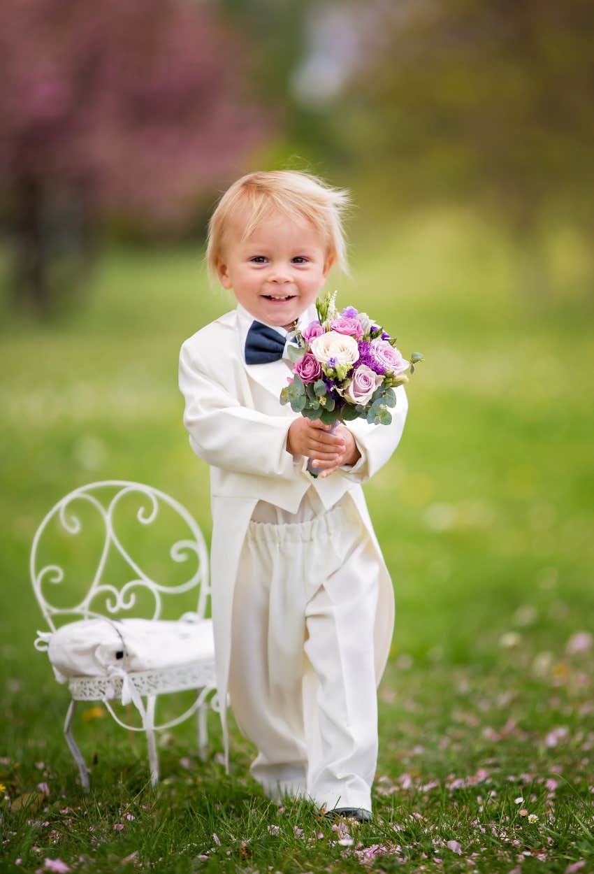 Little boy holding a bouquet at child-free wedding he wasn't invited to