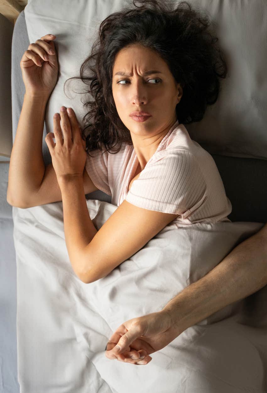 woman who has bad sleep while sharing a bed