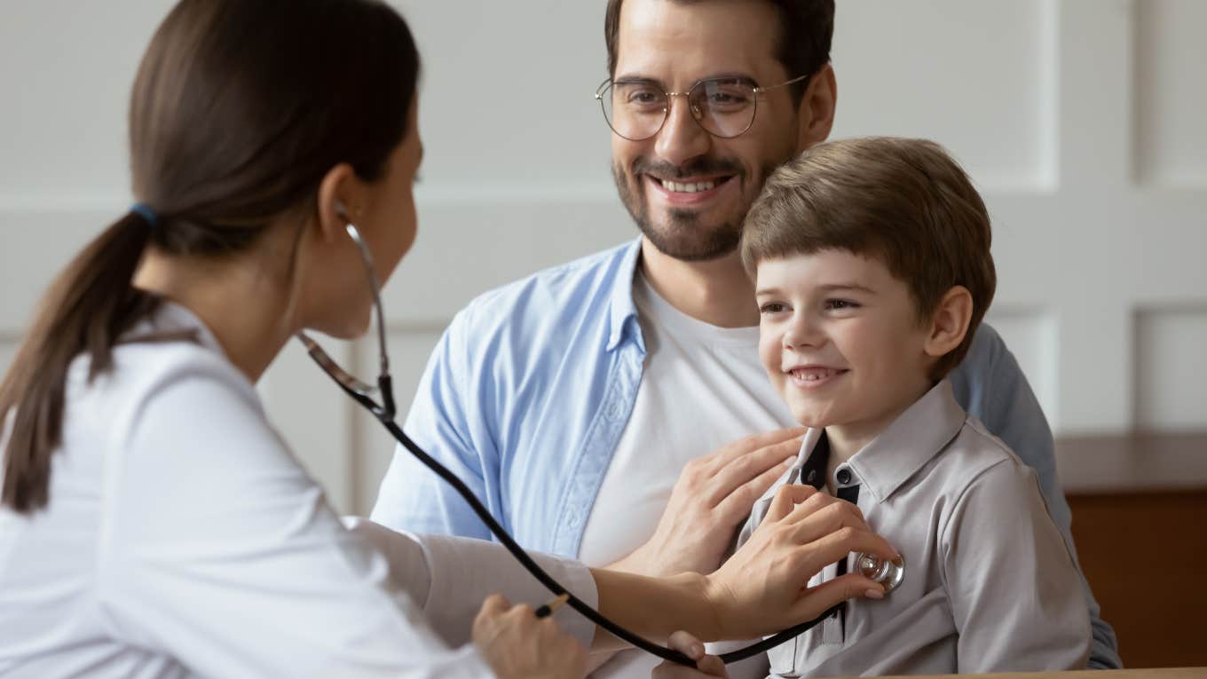 Dad Has No Idea How To Fill Out Forms At His Son's Doctor For The First Time Without Mom Dad at doctor's appointment with his son laughing because can't fill out forms