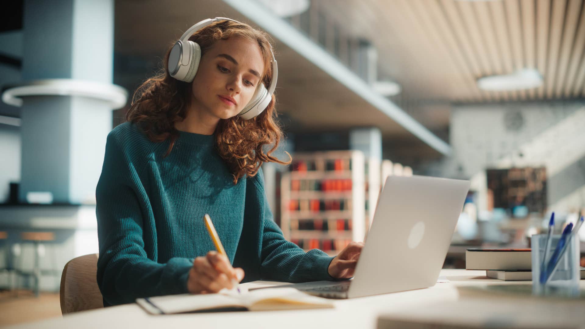 woman in blue sweater studying and focusing on herself first as she realizes she'll never be able to make everyone happy