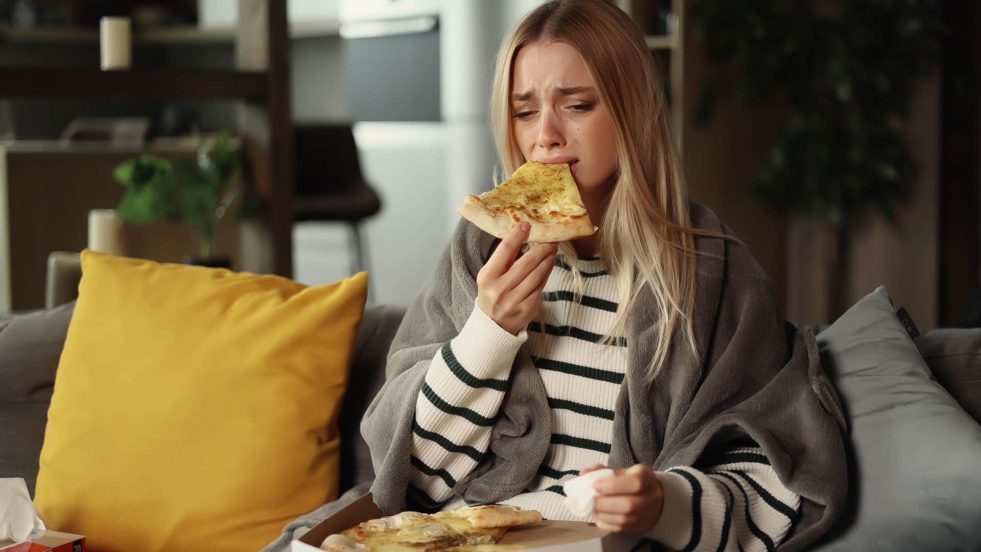 woman emotionally eating to avoid facing real emotions