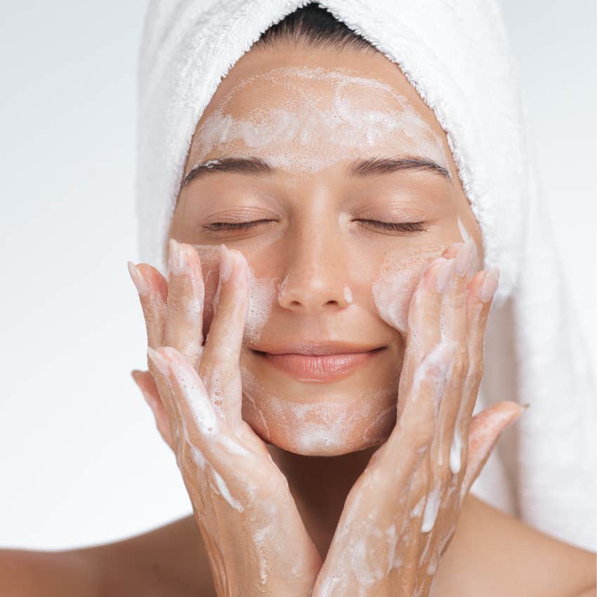 woman exfoliating skin to look younger