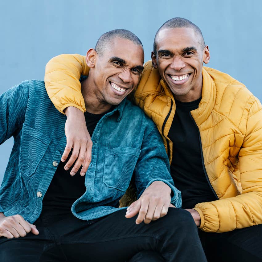 man sitting next to his doppelganger that is more likely than he thinks