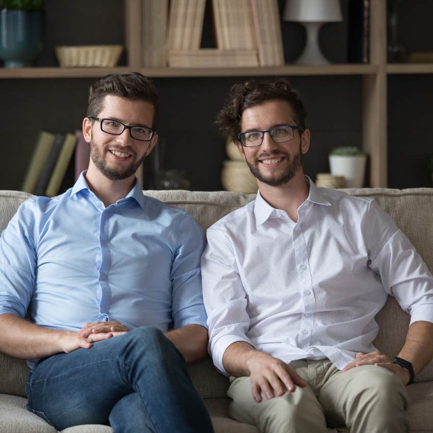 man sitting next to his doppelganger