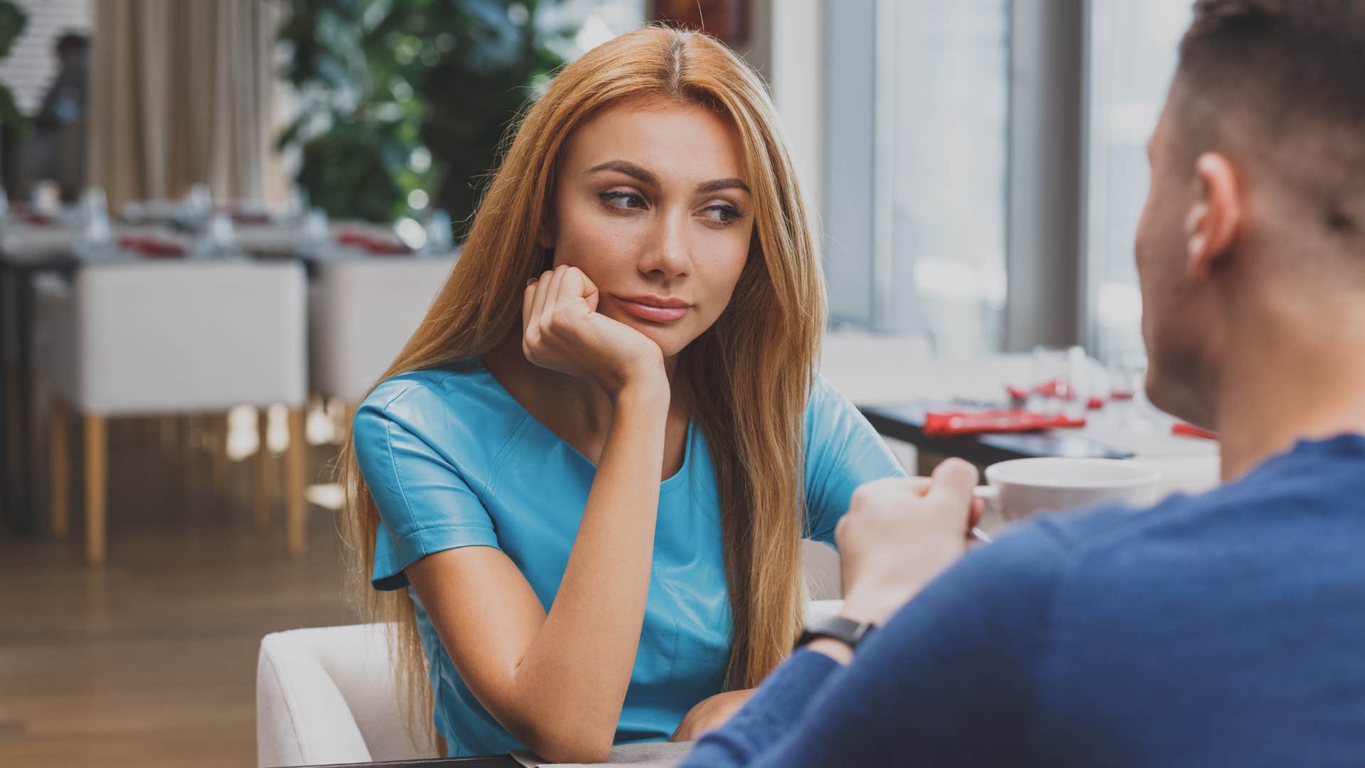 woman looking bored during conversation with husband
