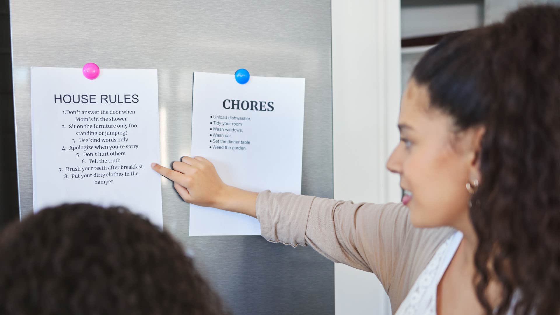 mom making a chore and house rules chart for her kids