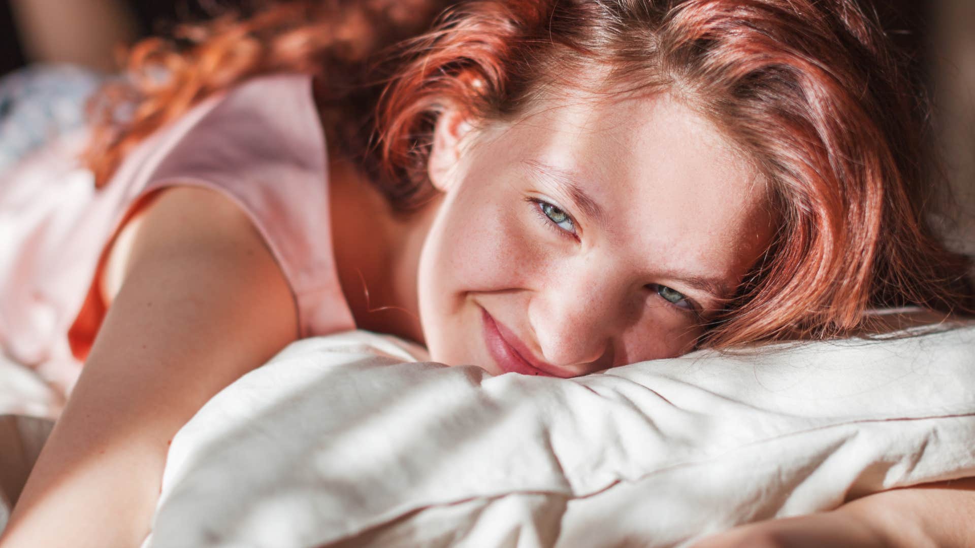 Happy woman sleeps alone as habit