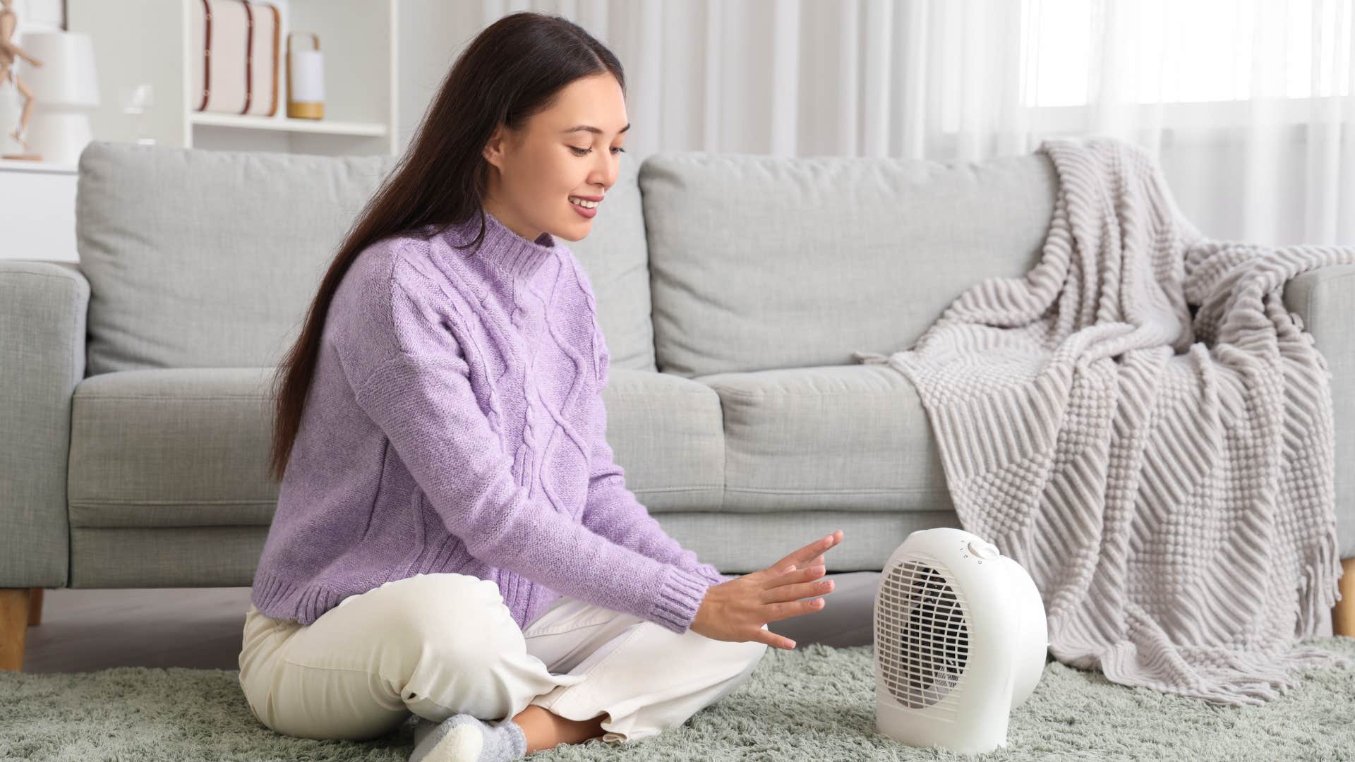 woman putting on a fan to keep her room cool for sleep