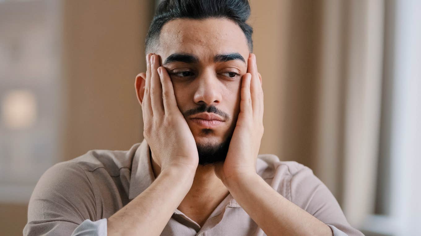 If You've Felt Distant From Everyone Lately, These Things Might Explain Why upset depressed man feeling distant from everyone