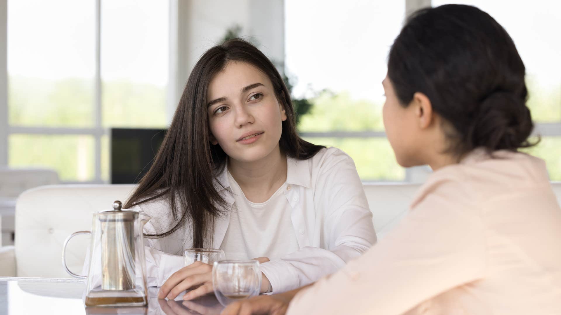 a woman actively listens to another woman speak about her issues